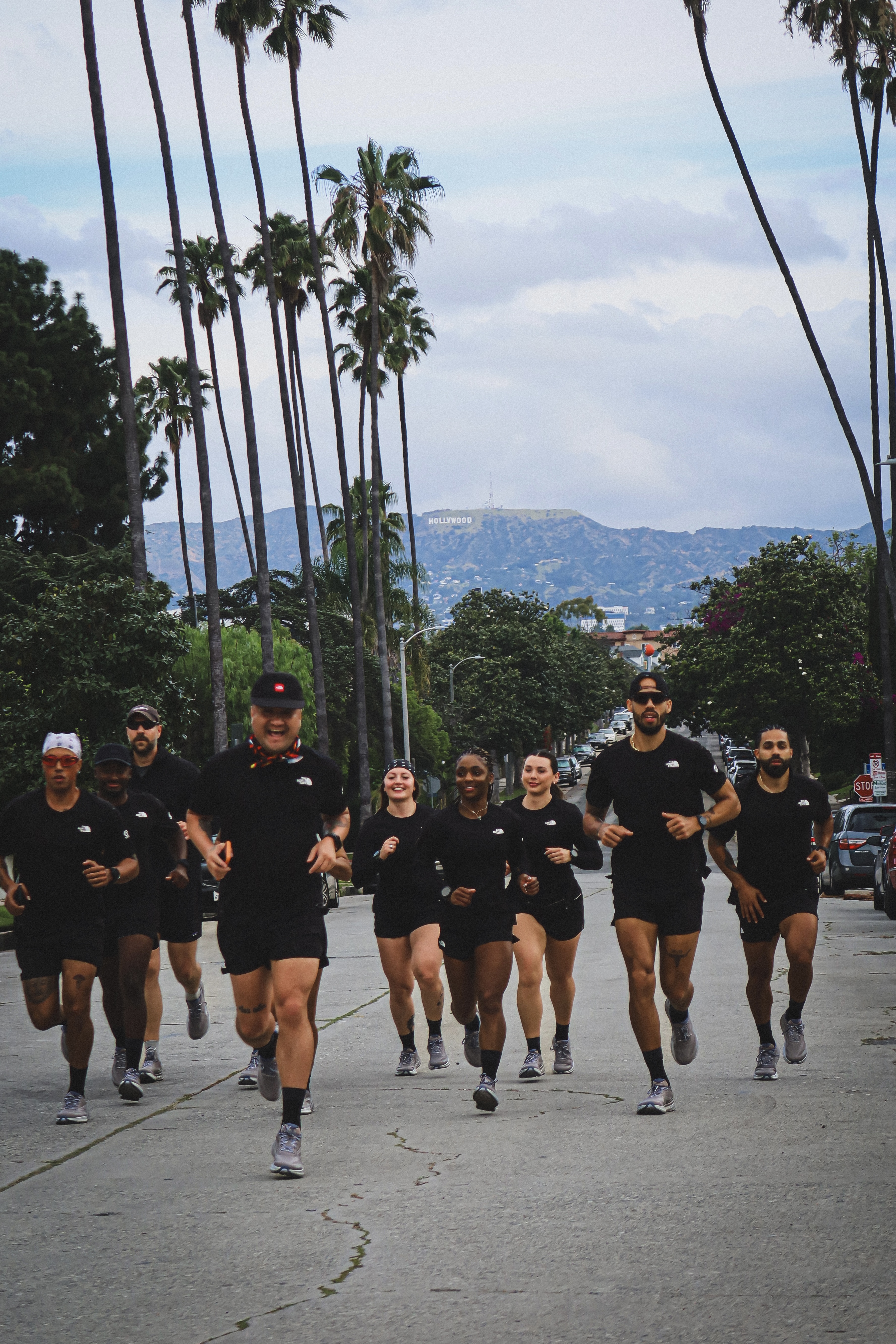 Oruzu crew running through palm-tree-lined streets